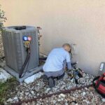 image of AeroDS tech performing hvac preventative maintenance on outdoor unit