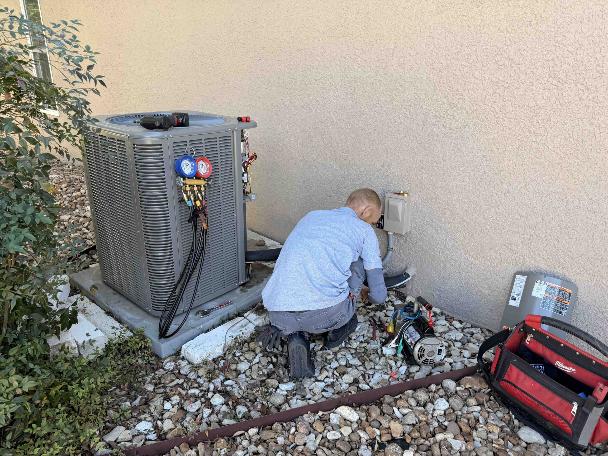 image of AeroDS tech performing hvac preventative maintenance on outdoor unit