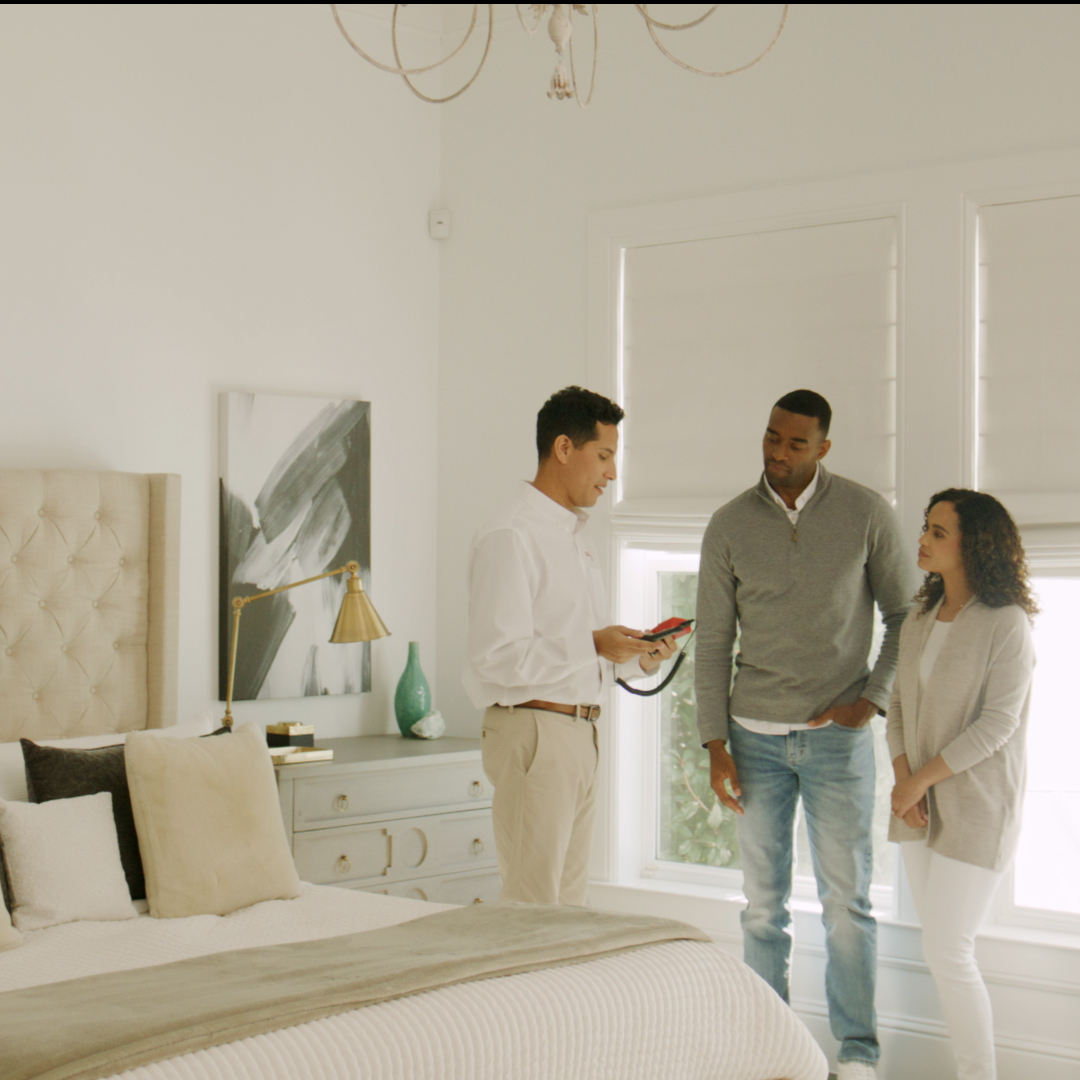 HVAC tech explaining the HVAC sales to a couple in their home