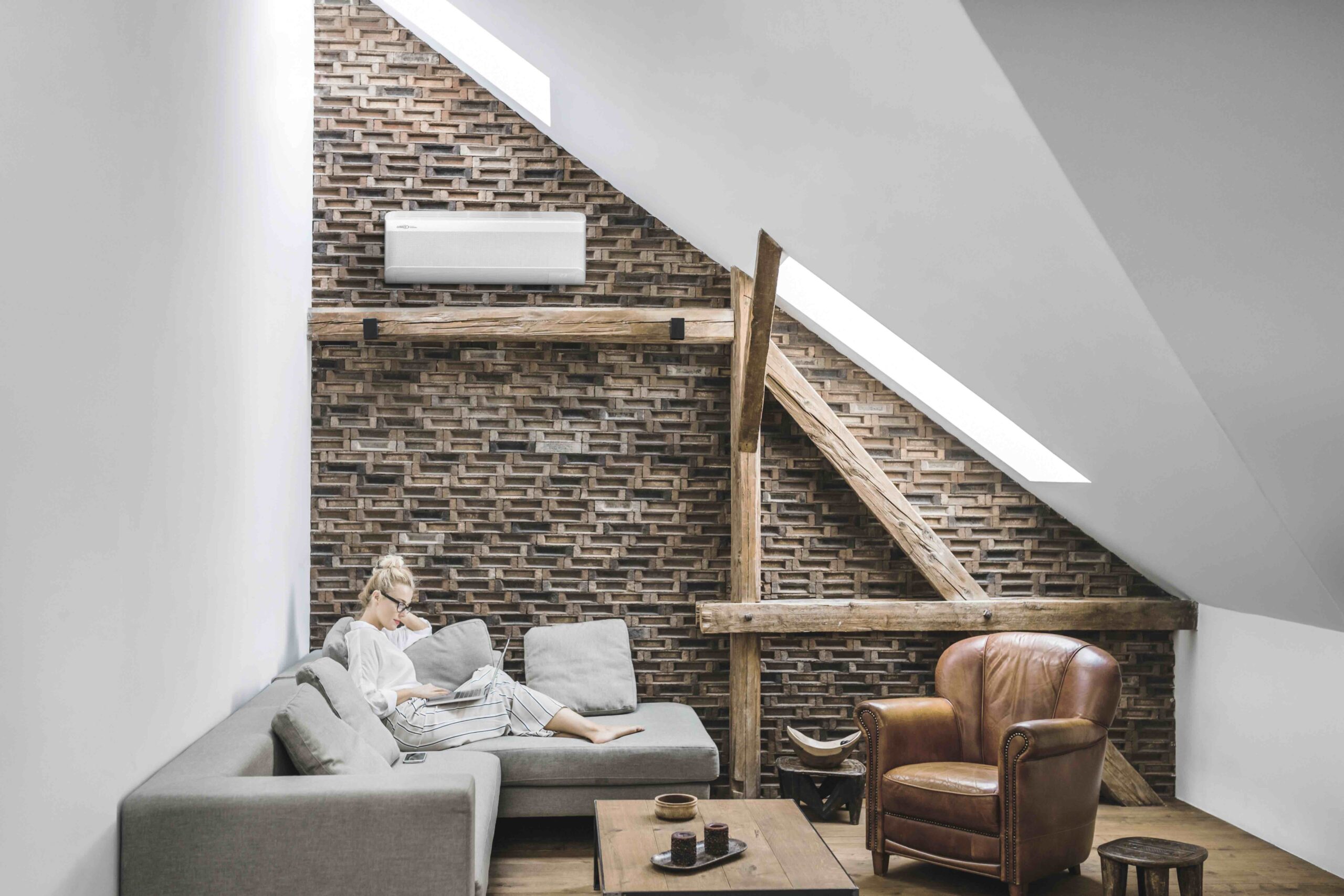 image of person in attic room with hvac mini split heat pump keeping the room cozy