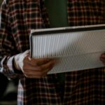 image of someone holding an air filter. Air quality services