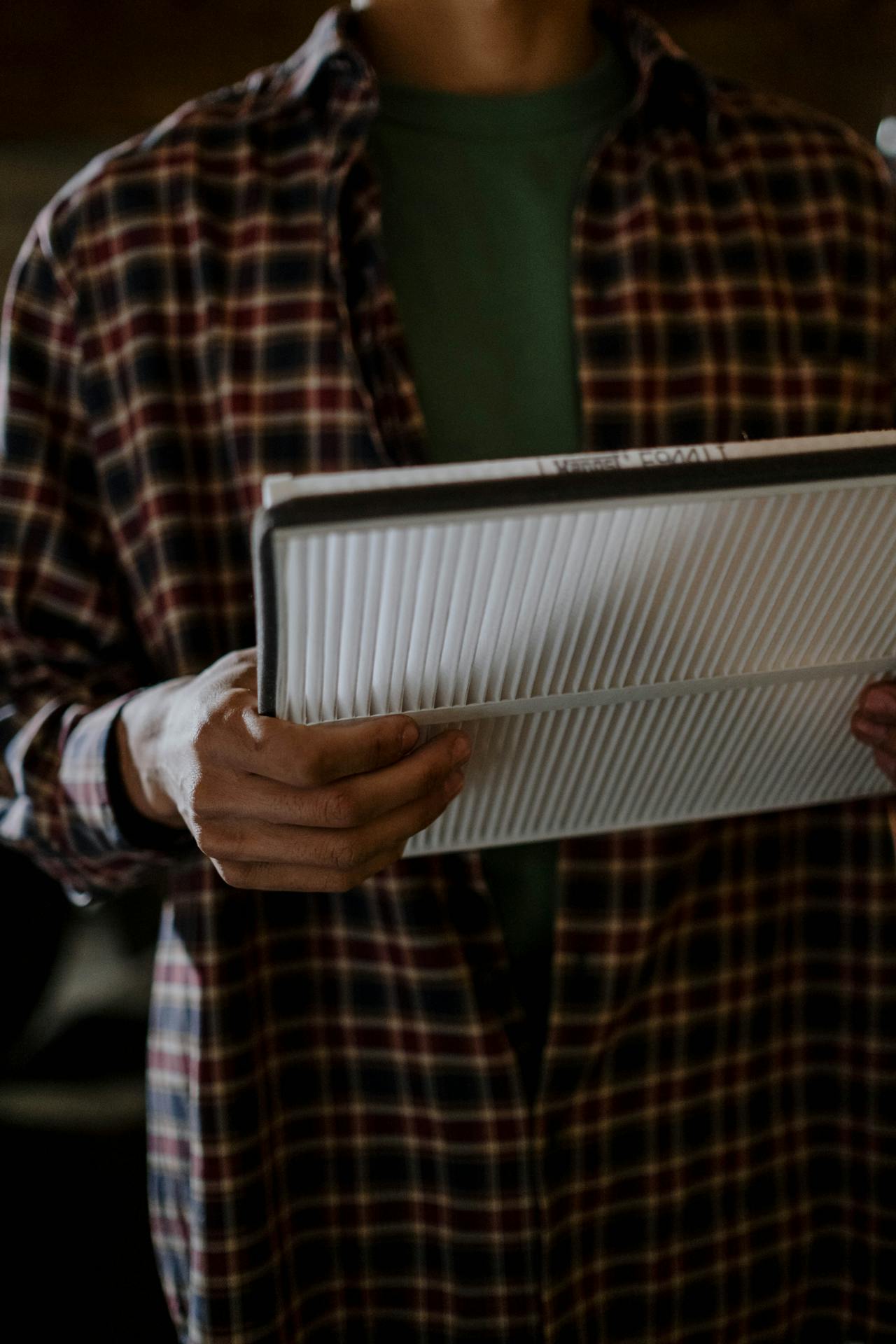 image of someone holding an air filter. Air quality services